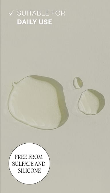 Revitalising Hair Tonic droplets texture on grey background and text suitable for daily use.