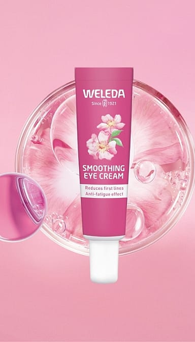 Smoothing Eye Cream Wild Rose & White Tea infront of a petri dish on a pink background.