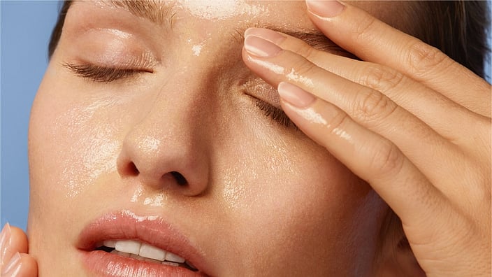 Woman cleansing her face with cleansing oil