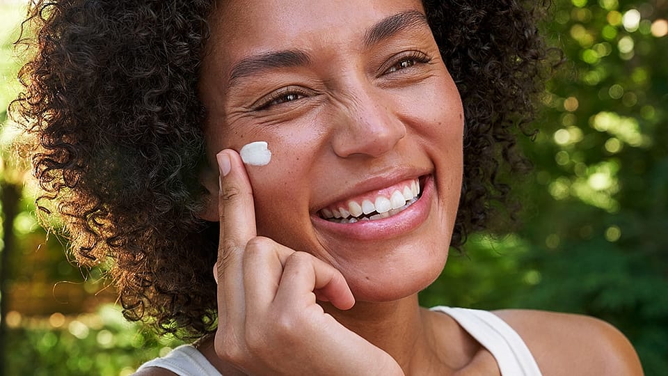 Girl smiling with cream on her face