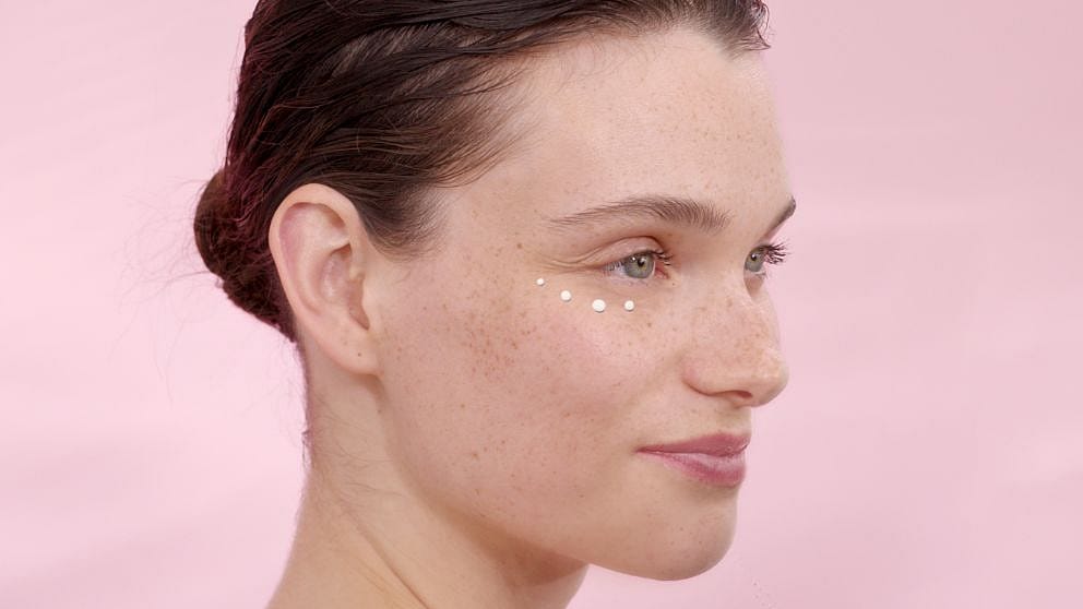 Woman with eye cream around her eyes